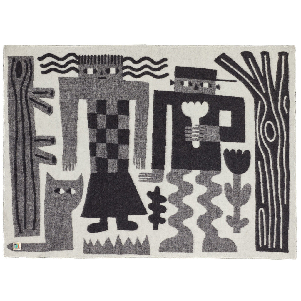 A black and grey rug featuring abstract figures and a cat, designed by Donna Wilson.