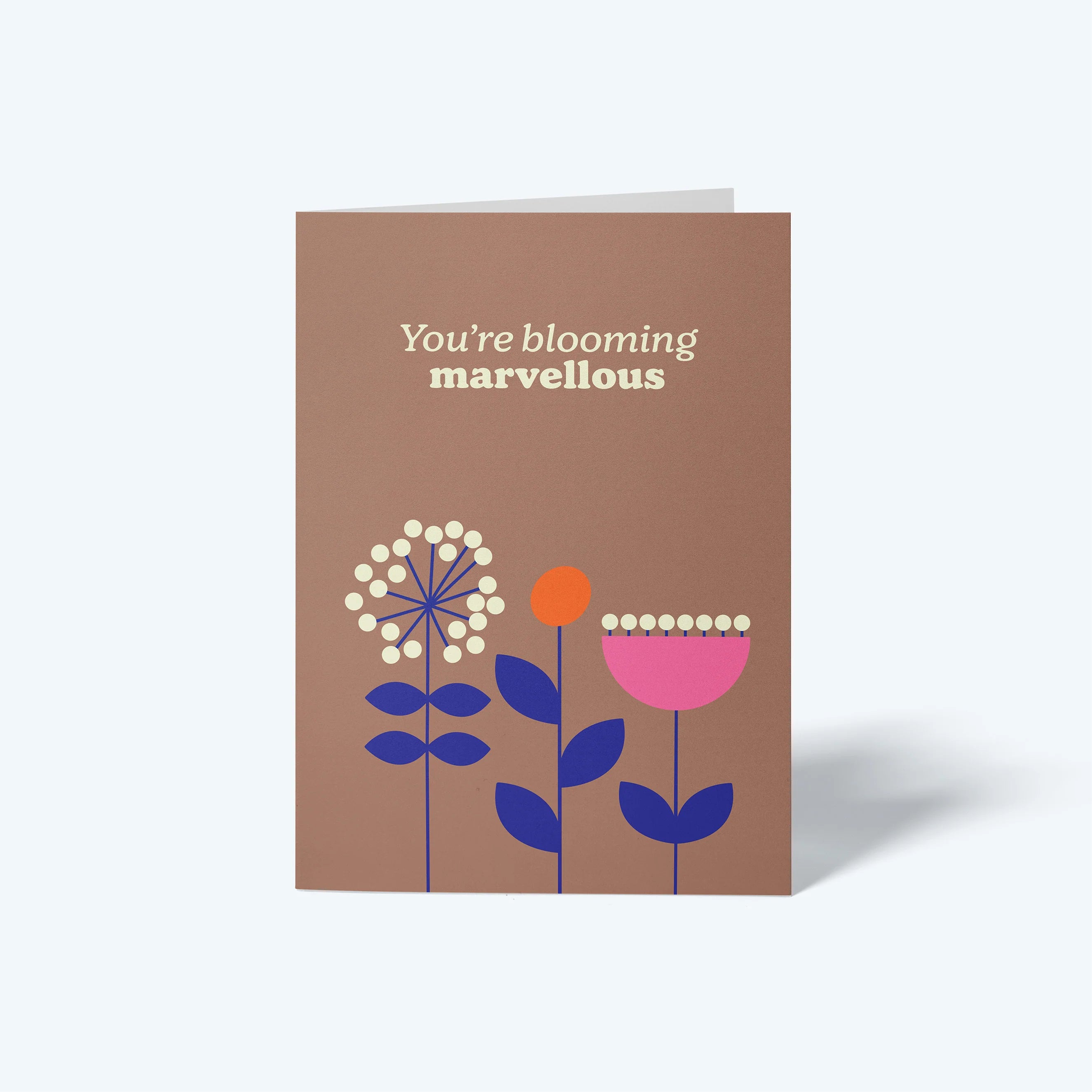 Greeting card with floral design and text 'You're blooming marvellous' on a brown background