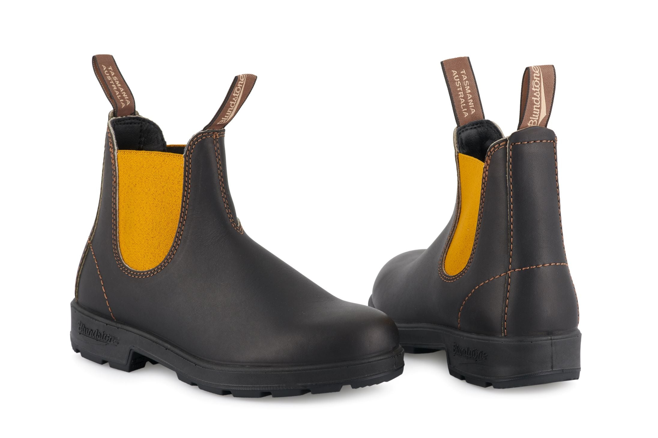 Pair of Blundstone Chelsea boots in dark brown leather with mustard yellow elastic side panels.
