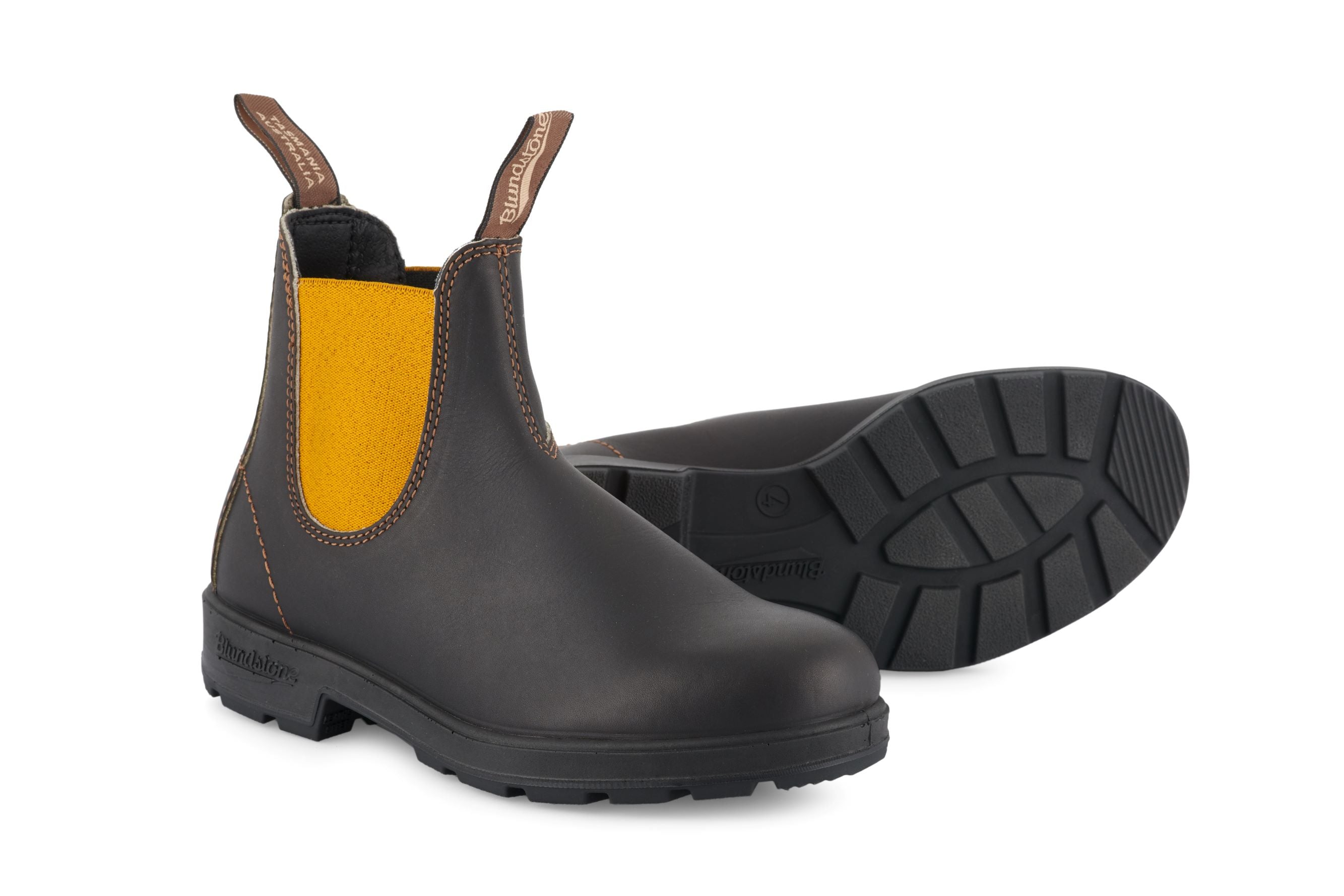 Pair of Blundstone Chelsea boots in dark brown leather with a mustard yellow elastic side panel.