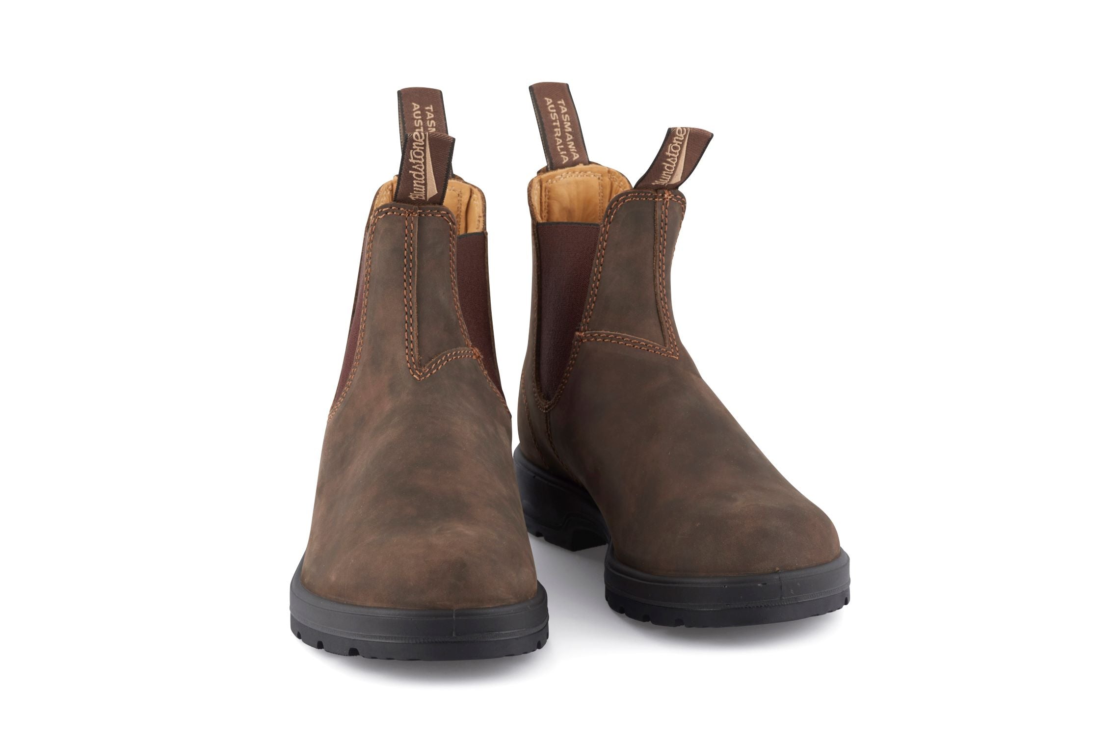 Pair of brown leather Blundstone Chelsea boots with black rubber soles.