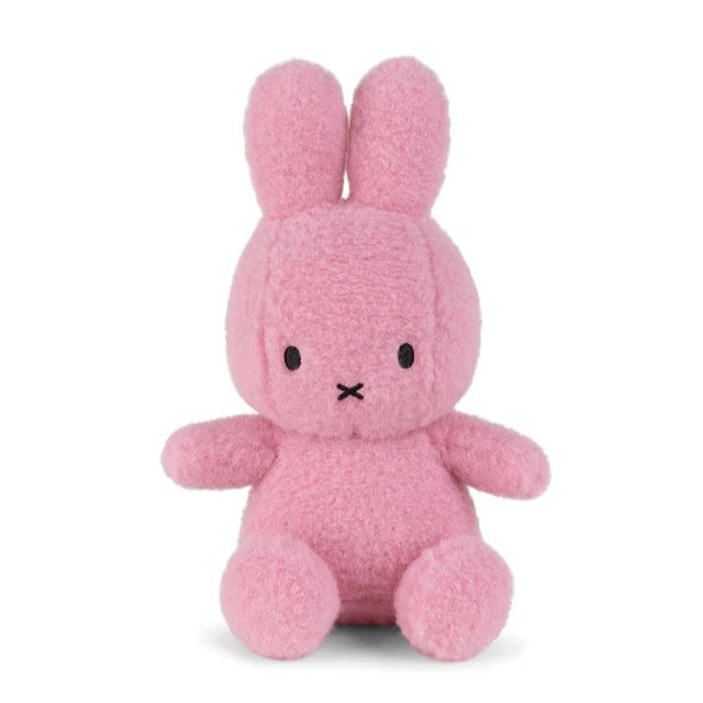 Pink plush Miffy bunny toy.  Soft, textured fur. Simple, embroidered facial features.