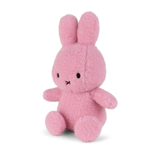 Pink plush bunny rabbit toy, sitting position, simple embroidered facial features.