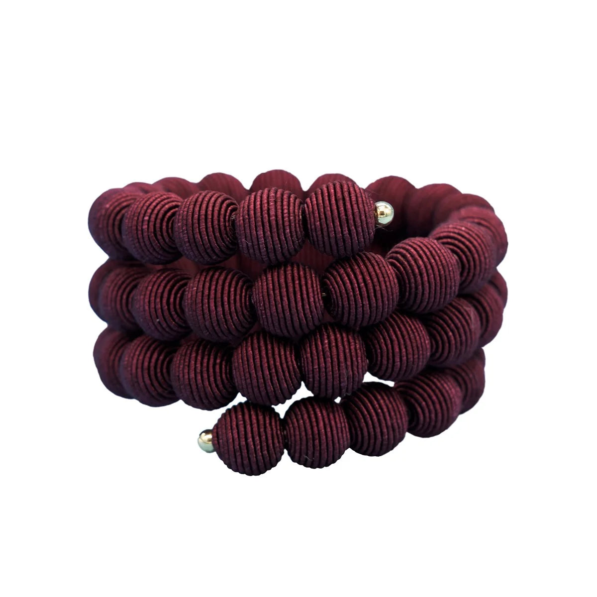 A stack of three dark burgundy beaded bracelets with textured, ribbed round beads and small metallic silver spacer beads, shown on a plain white background.