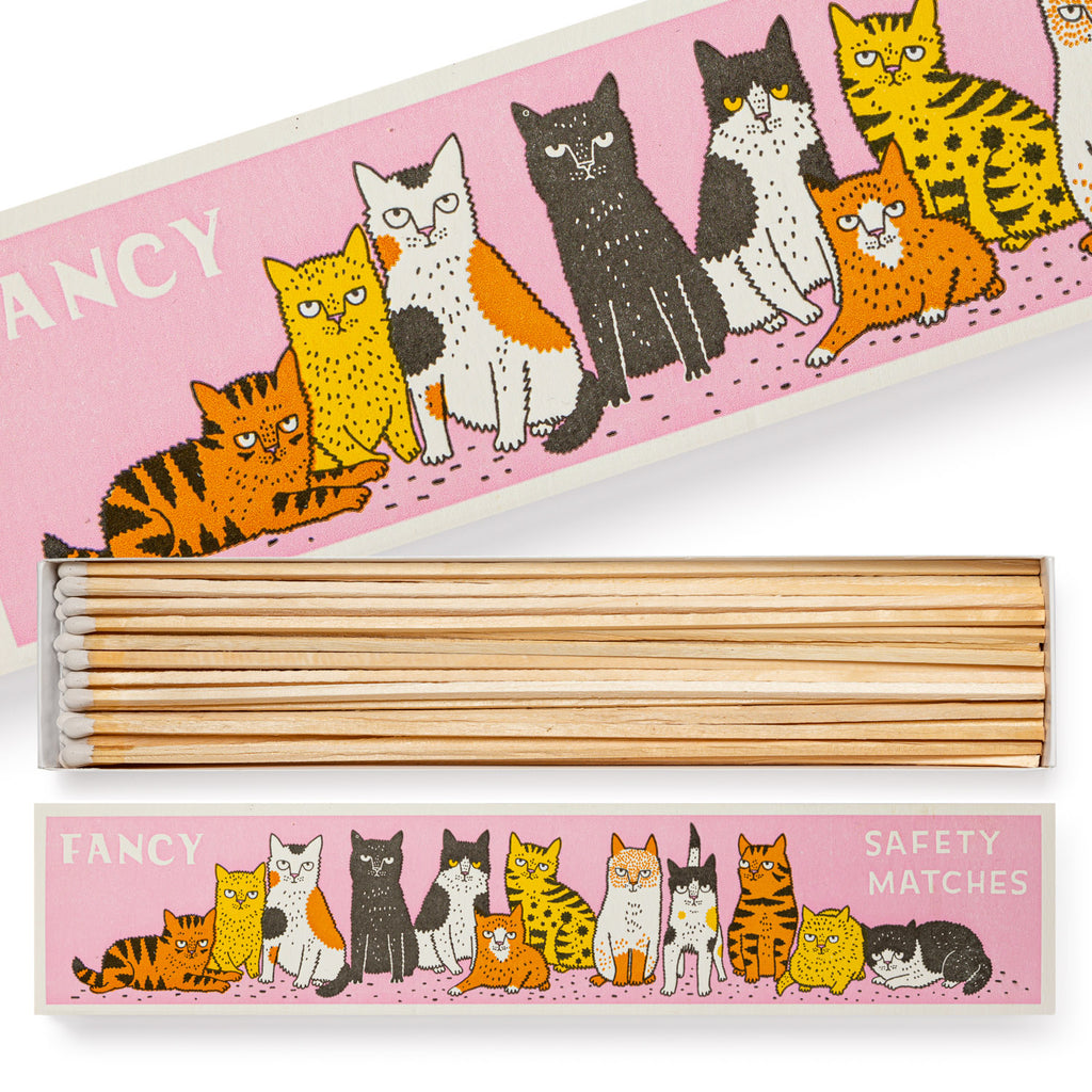 Box of safety matches featuring a pink label with a row of illustrated cats.