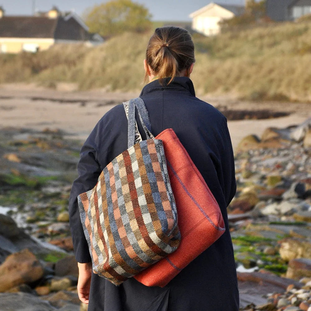 Woven tote bag in muted earth tones, featuring a plaid pattern.