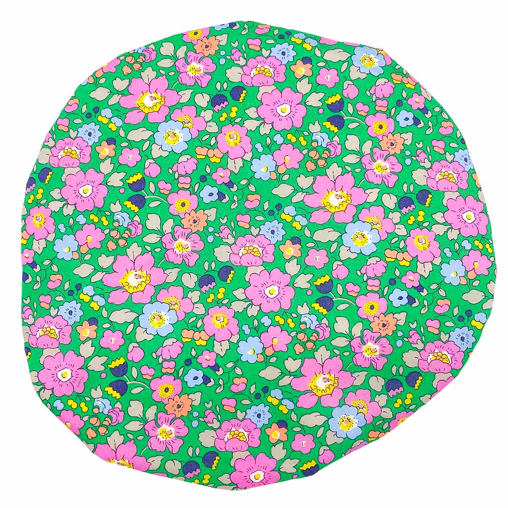 Round floral shower cap in bright green with pink, light blue, and orange flowers.