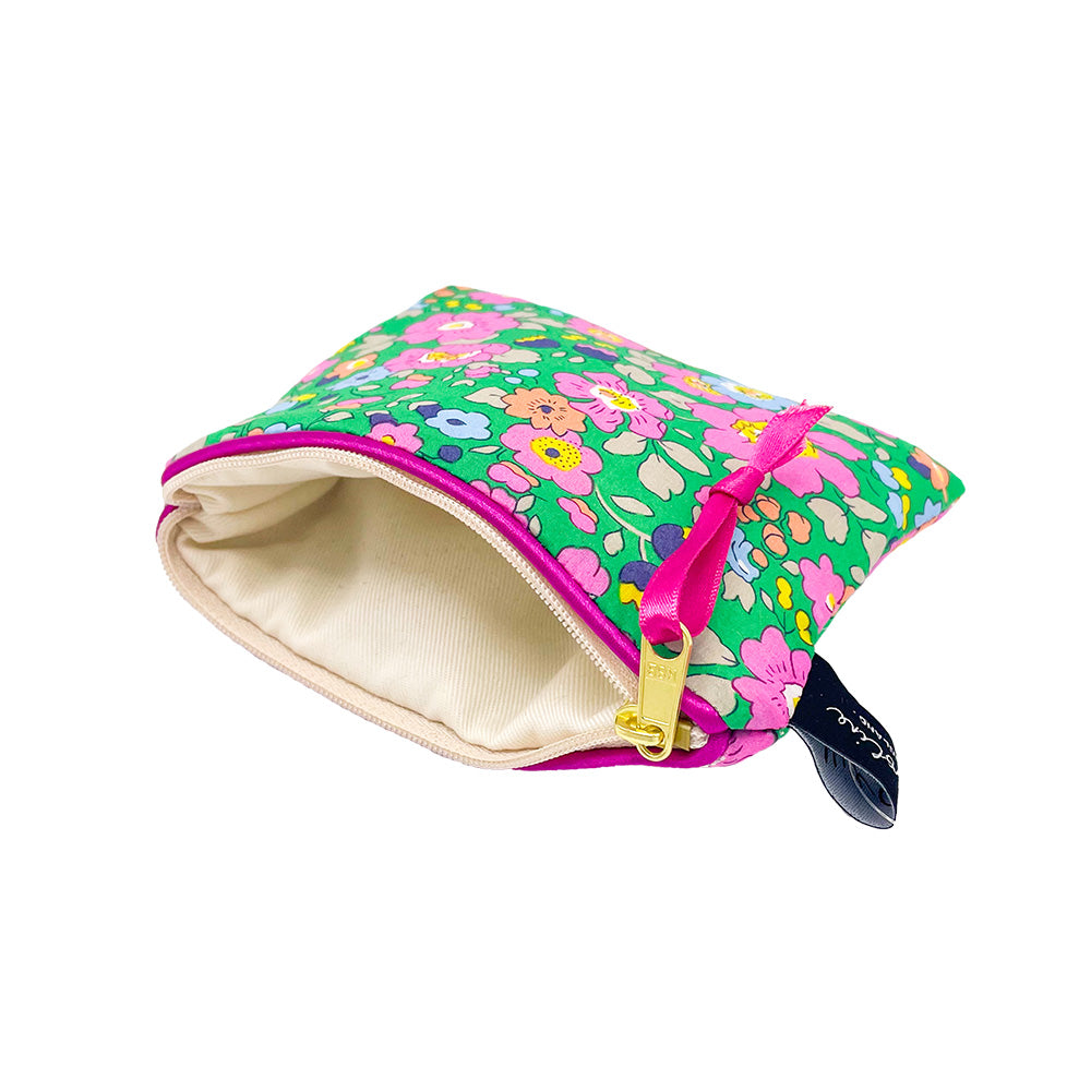 Green floral zipper pouch with pink trim and a small pink ribbon pull. The pouch is open, revealing a beige interior.