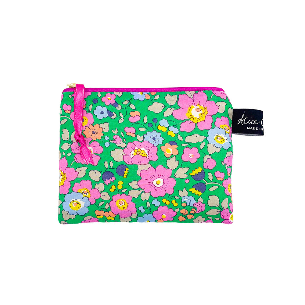 Green floral zipper pouch with pink ribbon pull. Features a repeating pattern of pink, blue, and orange flowers.