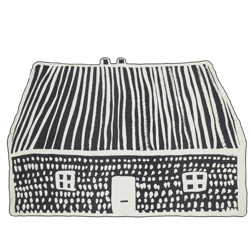 Black and white patterned cushion featuring a house design by Donna Wilson. Bold lines create a whimsical look.