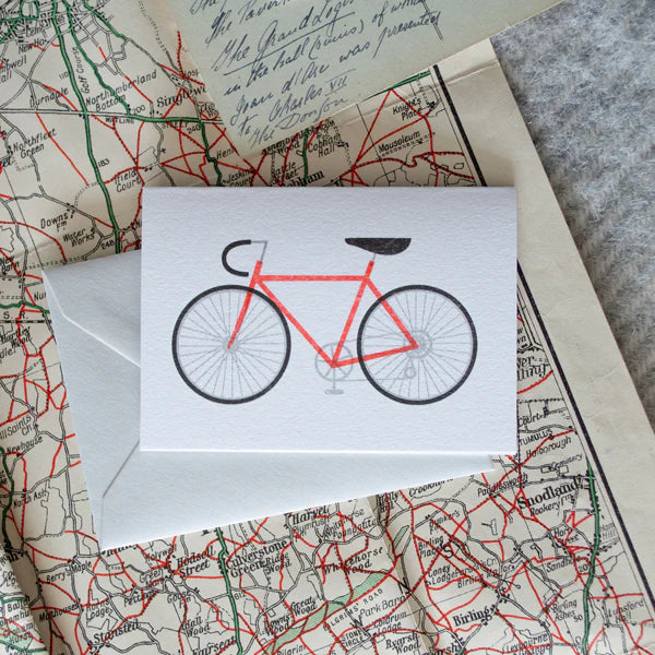 Red bicycle illustration on a white card.