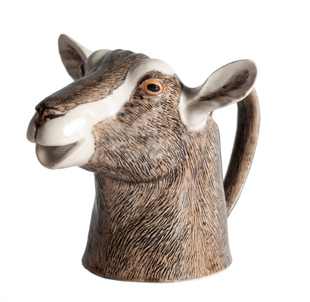 Goat-shaped ceramic pitcher on a white background