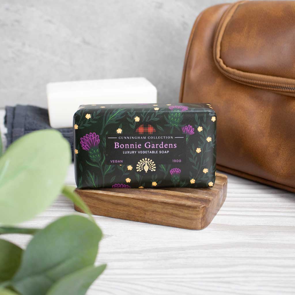 Bonnie Gardens Luxury Vegetable Soap, 190g, vegan, dark background with purple thistle and yellow flower illustrations.