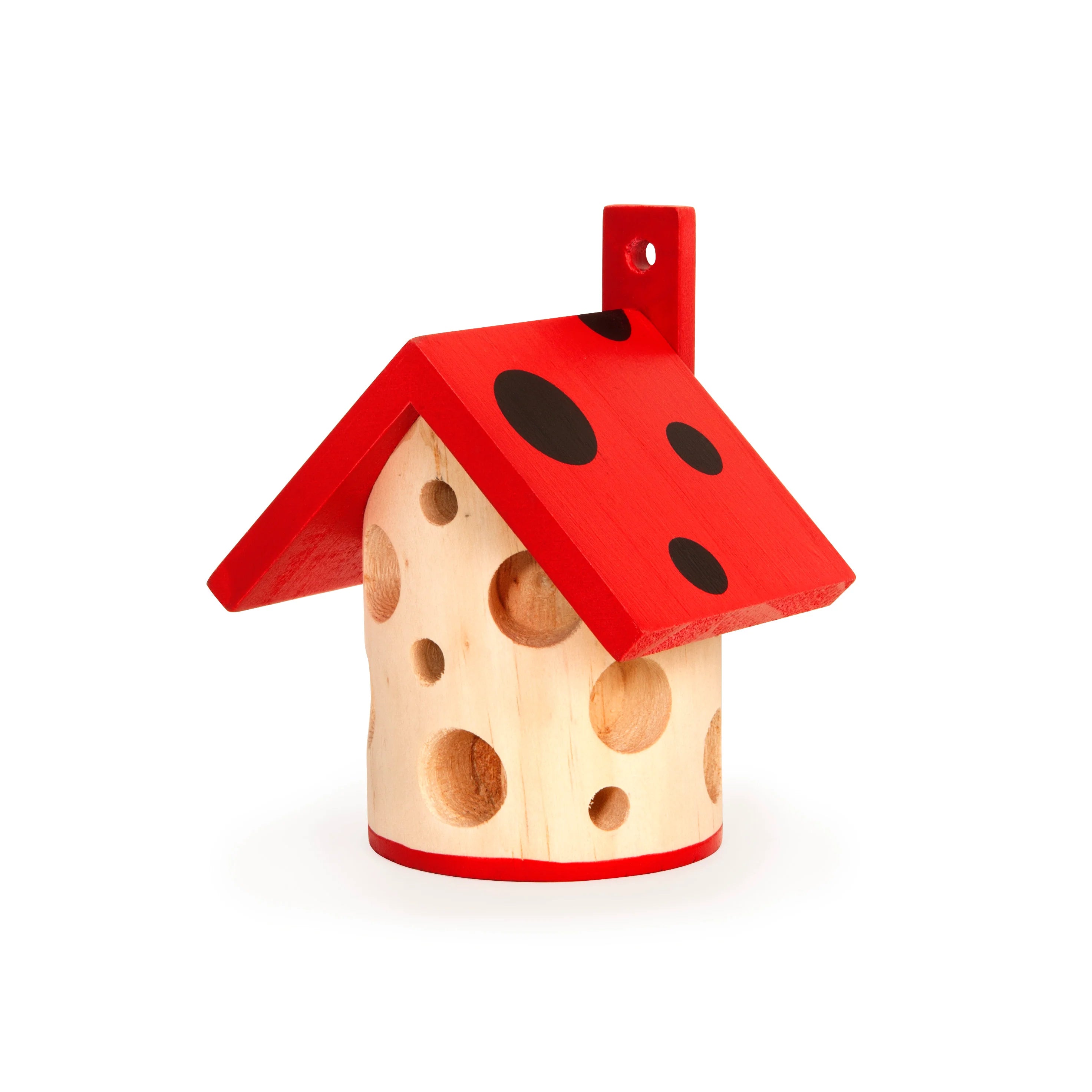 Wooden insect house shaped like a house with a red, polka-dotted roof and numerous holes in the light-colored body.