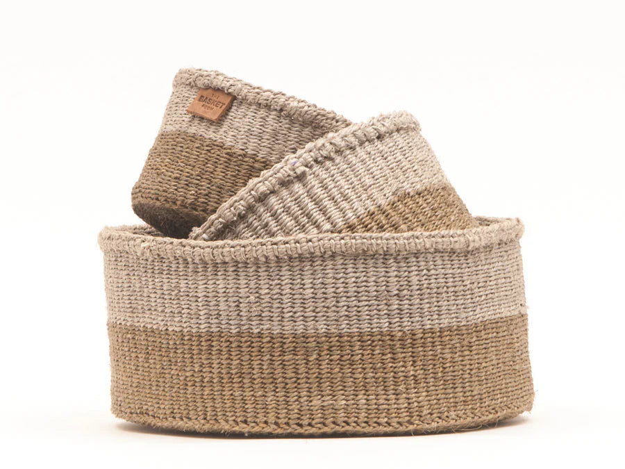 Set of two handwoven sisal baskets.  The larger basket is cylindrical with a two-toned design in beige and light brown.