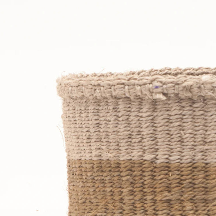 Close-up of a cylindrical woven basket with a two-toned design.