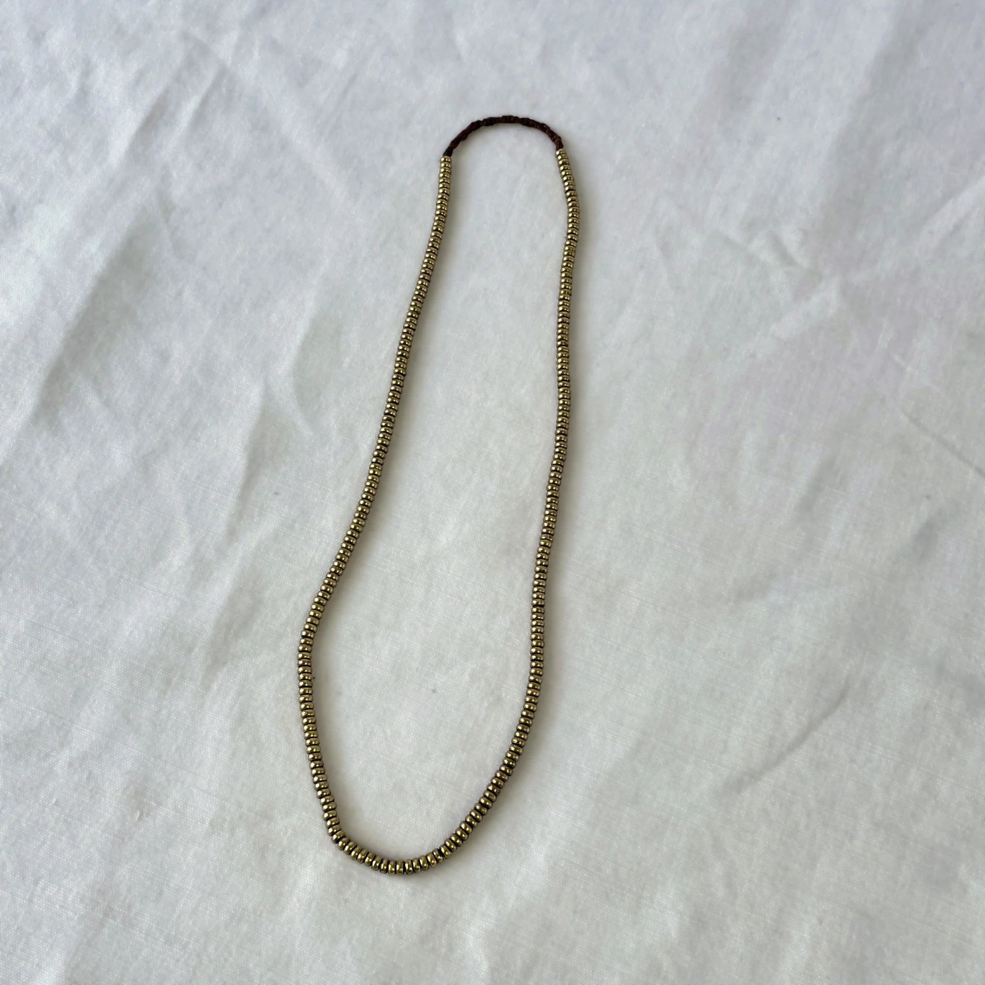 Beaded necklace on a white fabric background