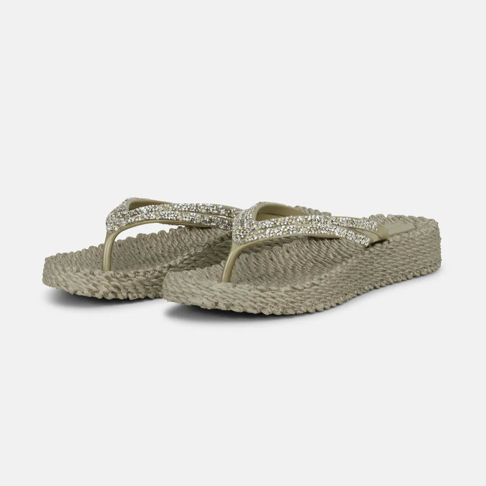 Pair of taupe textured flip-flops with sparkly rhinestone straps.