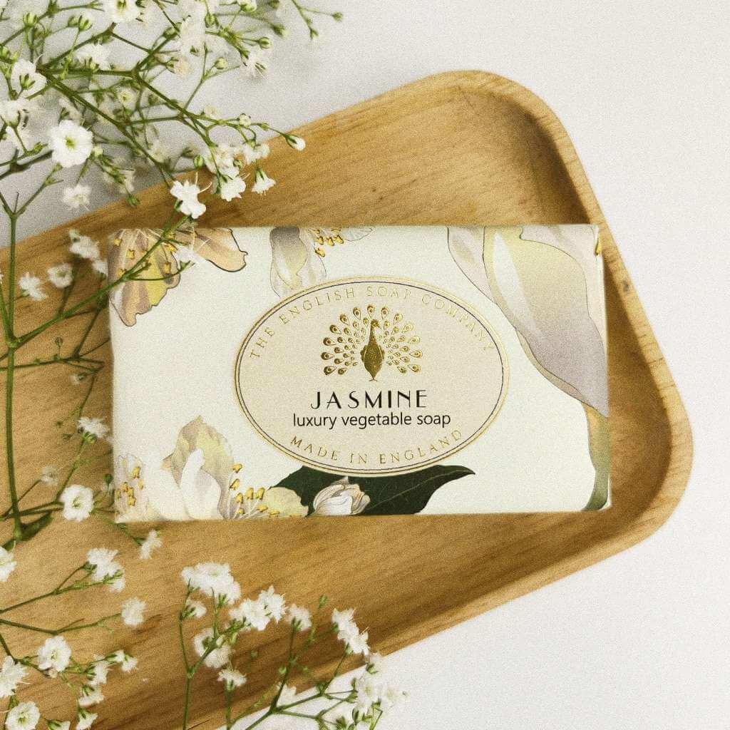 The English Soap Company Jasmine luxury vegetable soap bar, featuring a peacock logo and floral design.