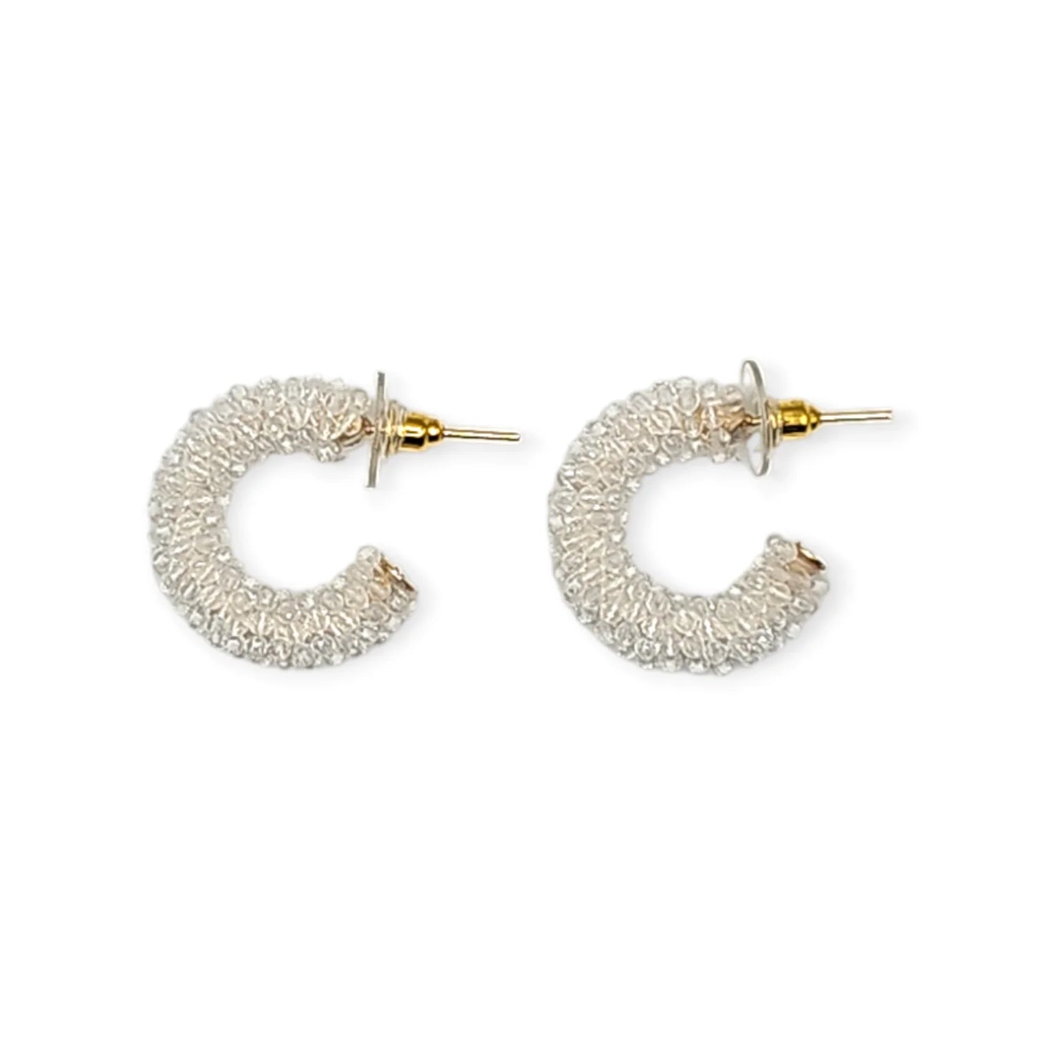 Pair of pearl hoop earrings on a white background