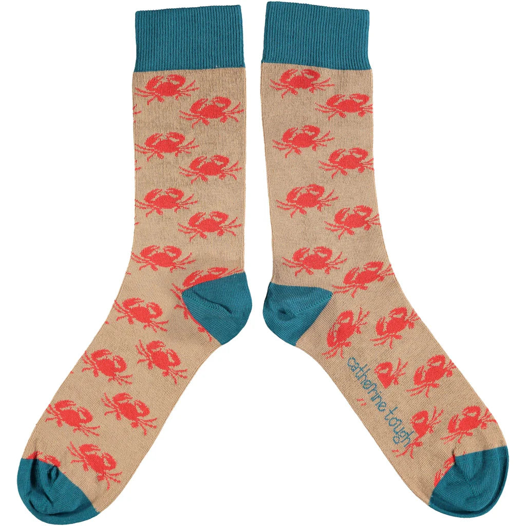 Pair of beige crew socks with a repeating pattern of red crabs and teal cuffs.