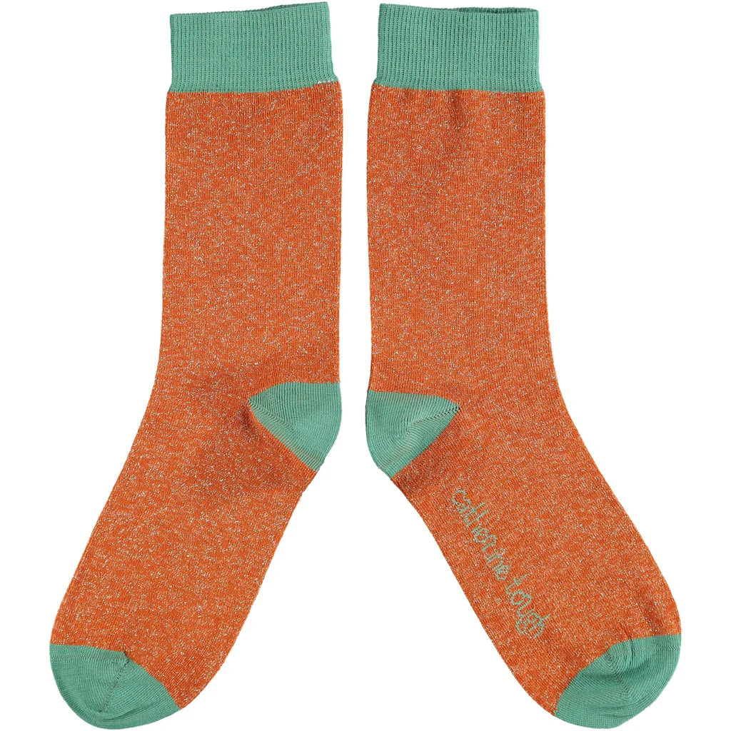 Pair of orange glitter socks with teal cuffs.