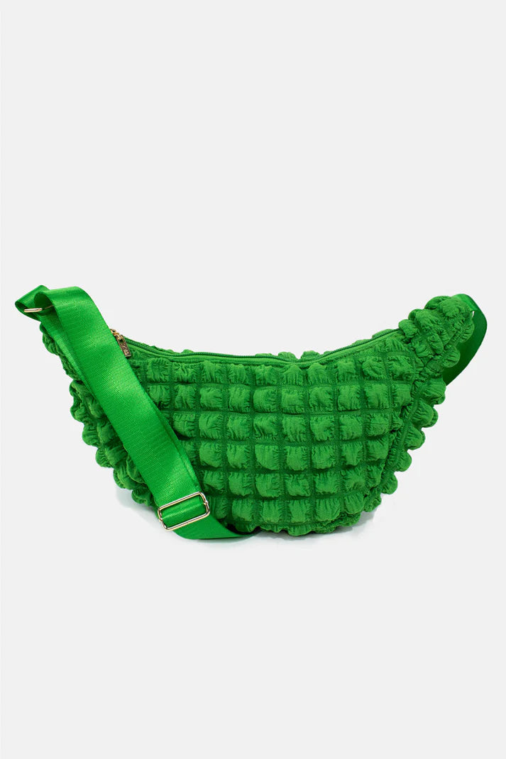 Bright green quilted fanny pack with adjustable shoulder strap.