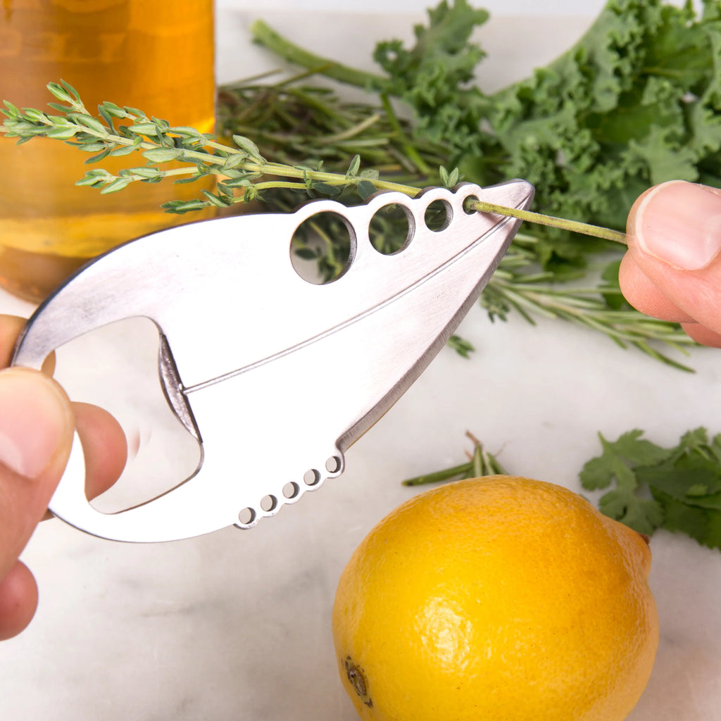 Silver herb stripper with five holes and bottle opener, used to remove leaves from stems.