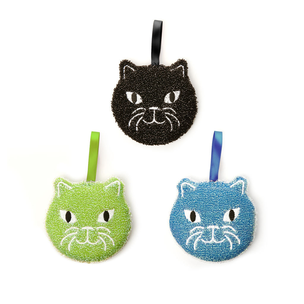 Three textured cat-shaped scrubbers in black, lime green, and blue.  Each features embroidered white eyes and whiskers.