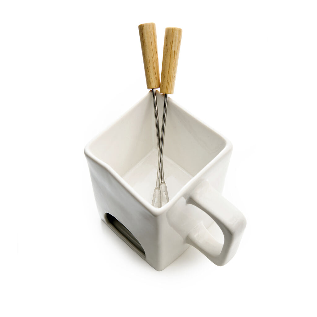 White ceramic fondue pot with two wooden-handled dipping forks.