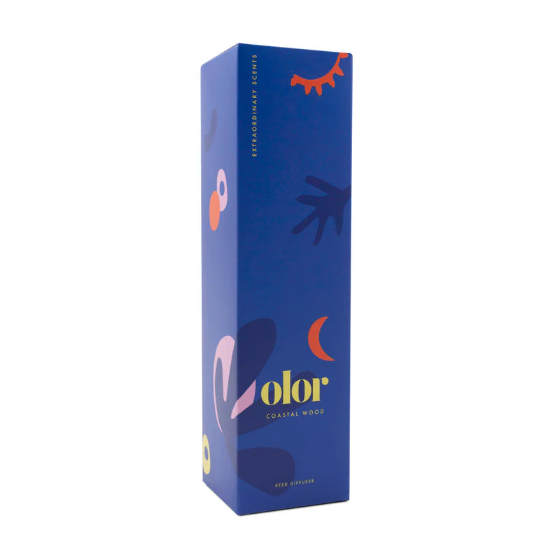 Color Coastal Wood reed diffuser in a blue box with abstract shapes and celestial design elements.