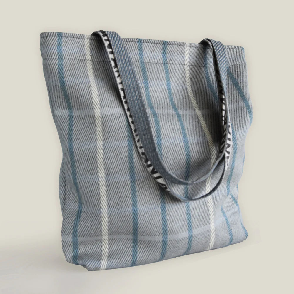 Blue and white striped tote bag with dark gray and white striped handles.