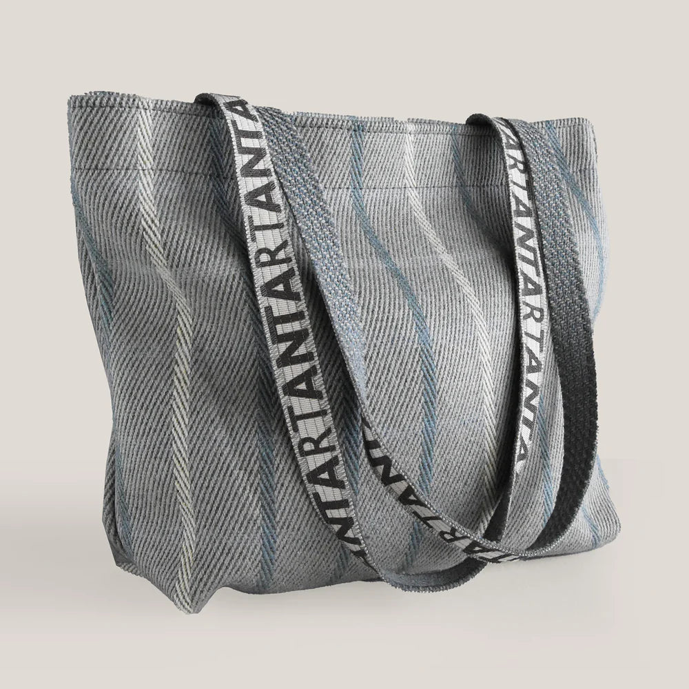 Gray tweed tote bag with long fabric straps featuring repeating "RIANTARTANZA" branding.