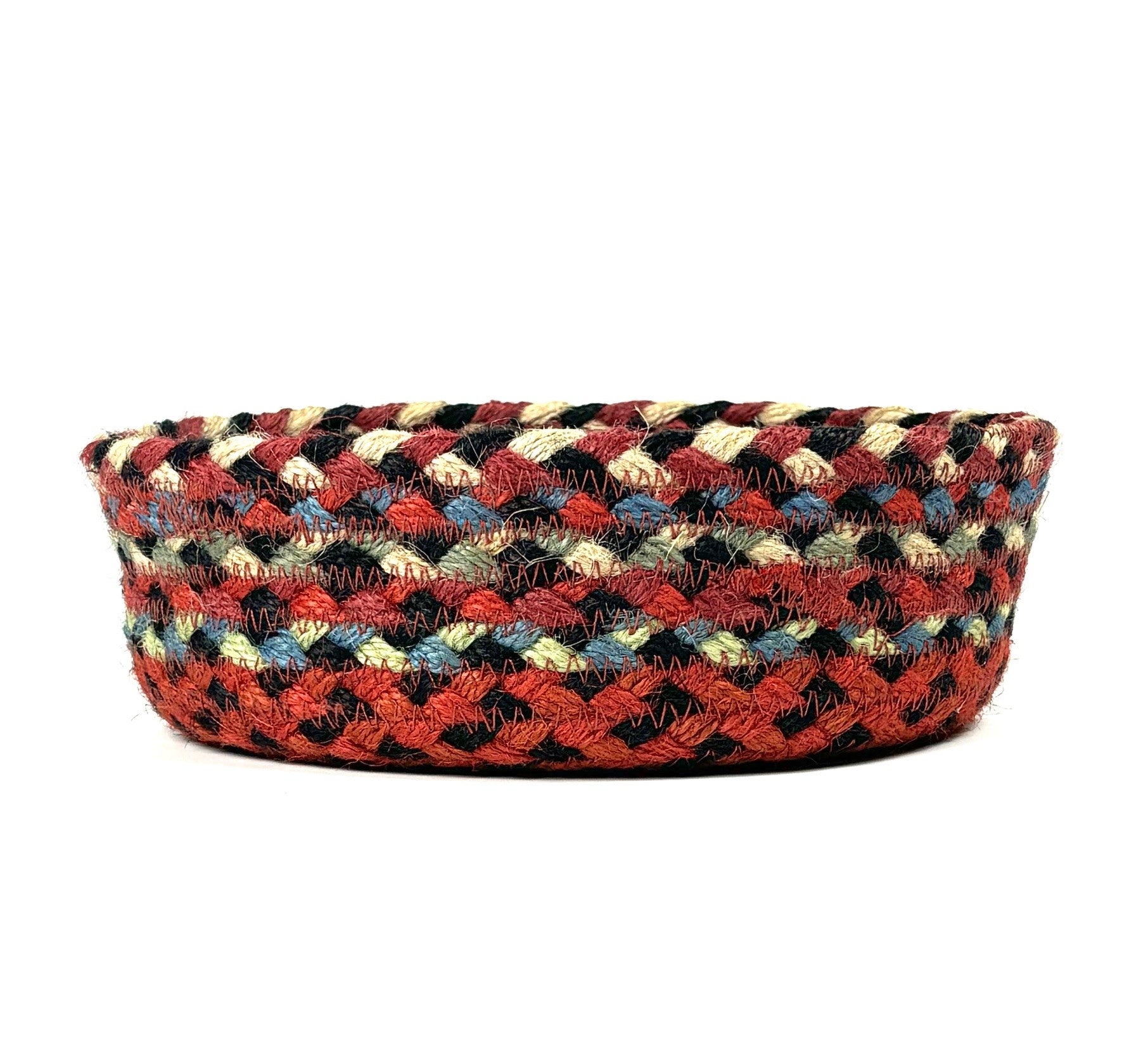 Round braided jute basket with red, black, beige, and blue stripes.