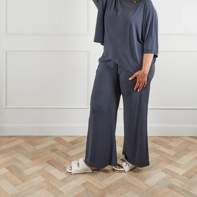 Dark gray wide-leg lounge pants and matching loose-fitting top.