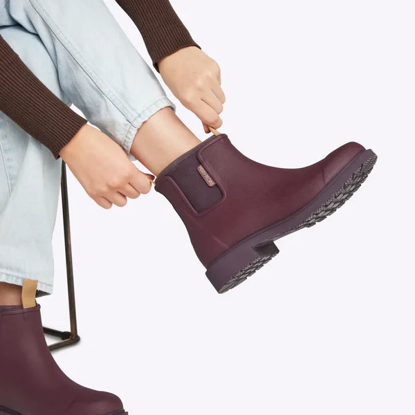 Burgundy ankle rain boots with a lug sole and pull tab.