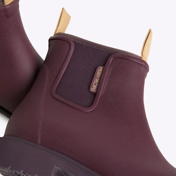 Burgundy Merry People ankle rain boots with a textured matte finish and tan pull tab.