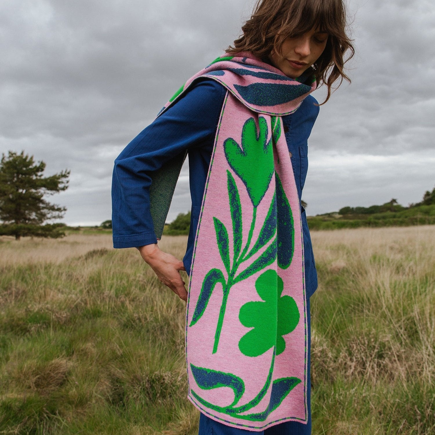 Pink and green floral patterned scarf.  Knitted wool, stylized botanical design.