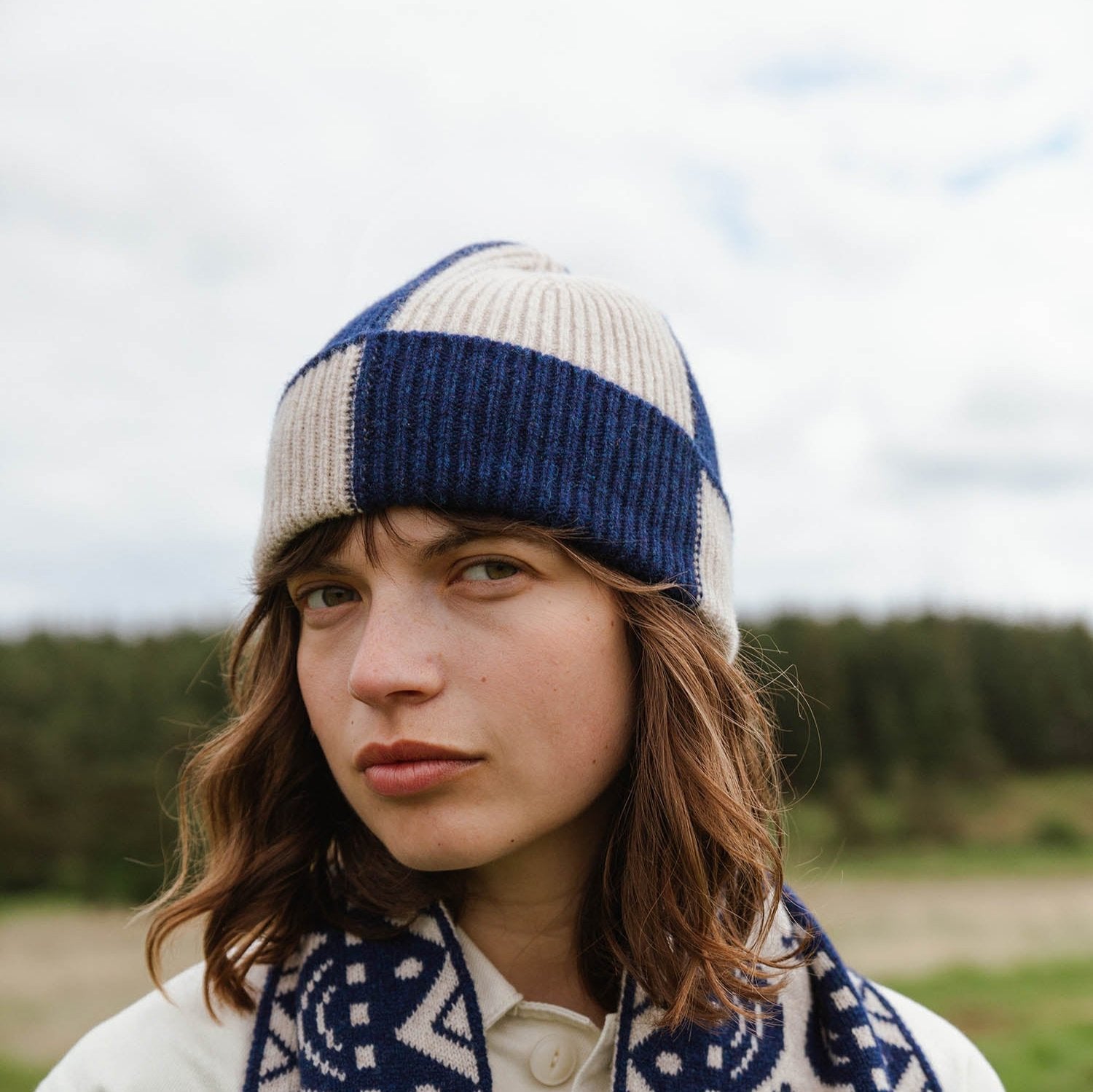 Color-blocked wool beanie in beige and navy blue.