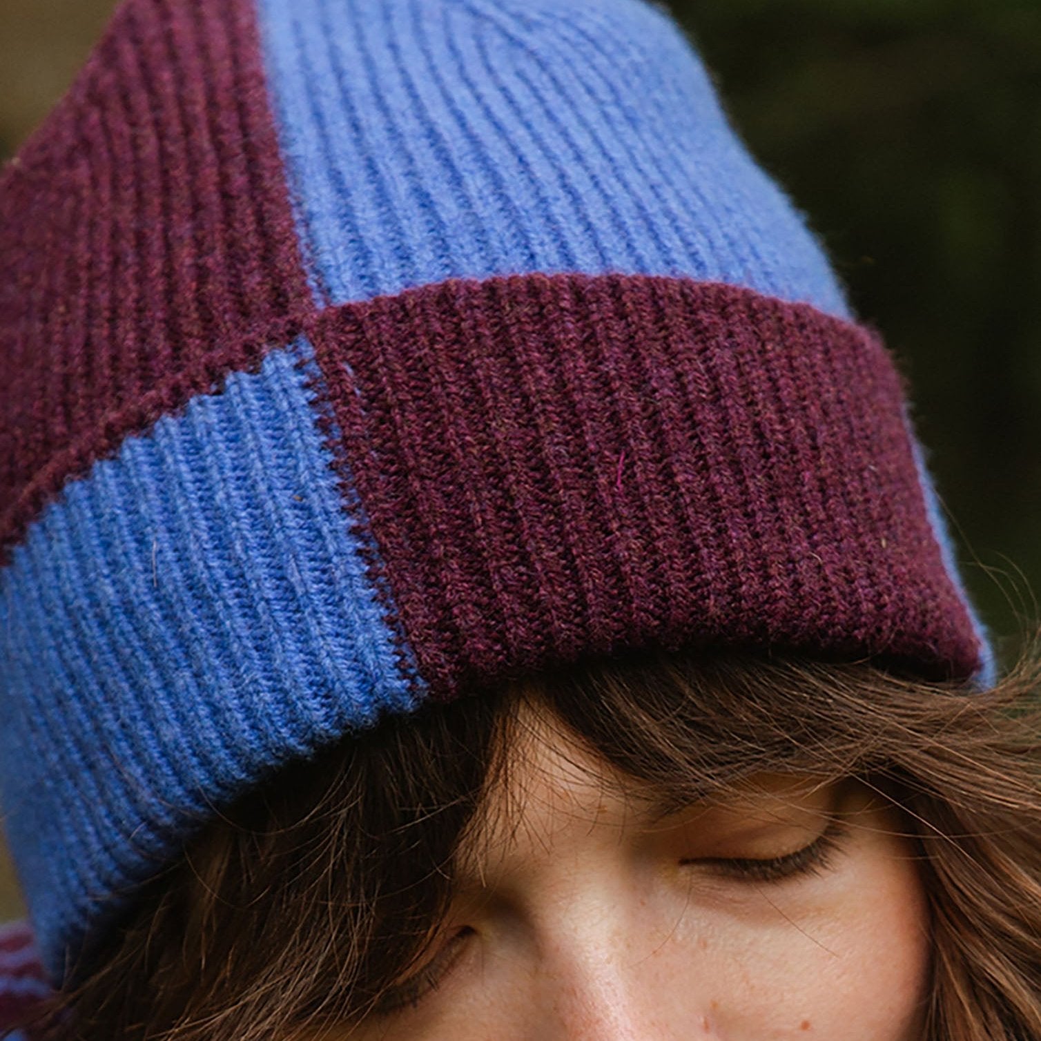 Color-blocked beanie in shades of purple and blue.  Knit ribbed texture.