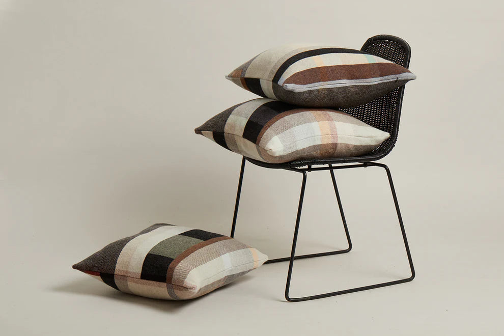 Chair with patterned cushions on a neutral background