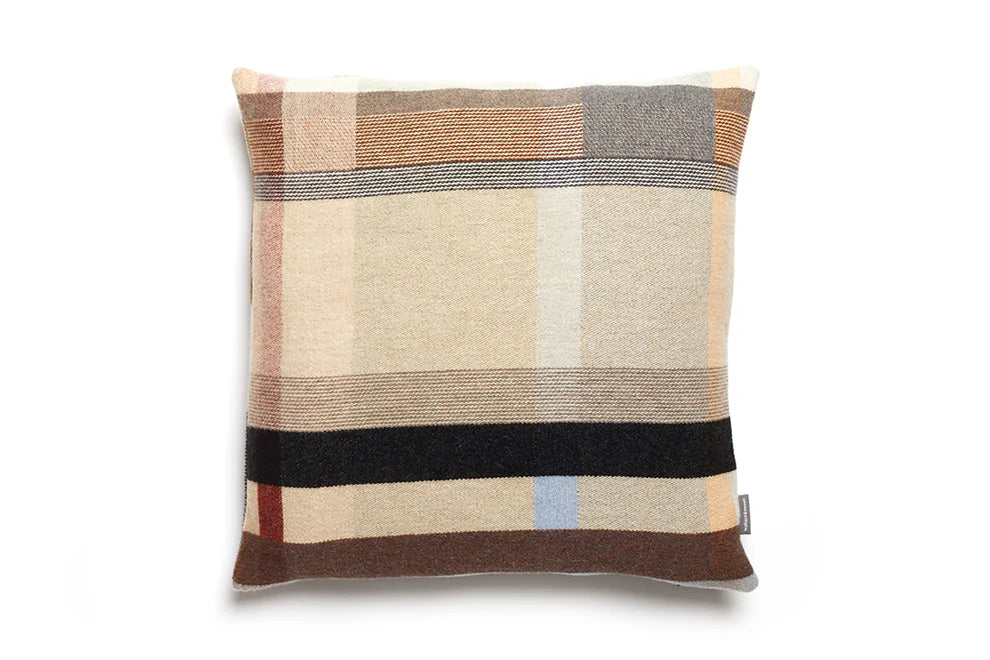 Plaid patterned pillow with a visible brand tag on a white background