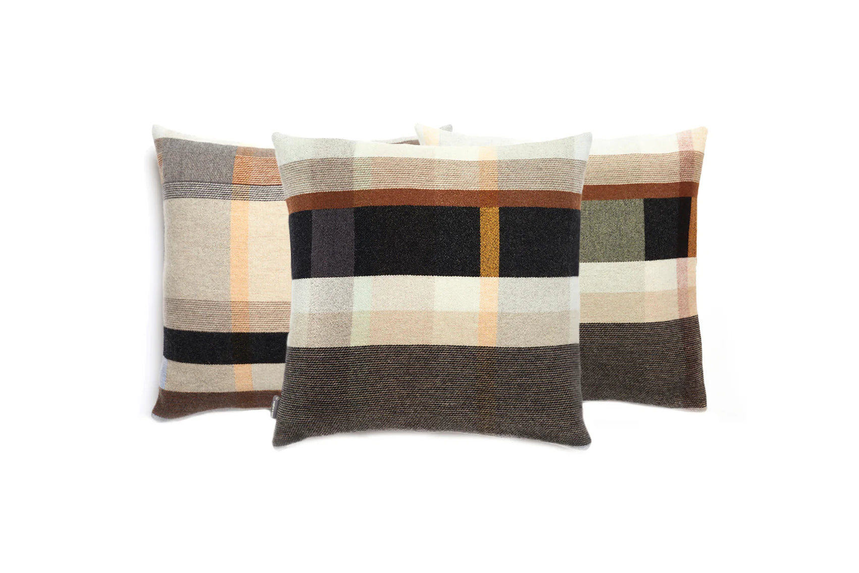 Three plaid patterned pillows on a white background