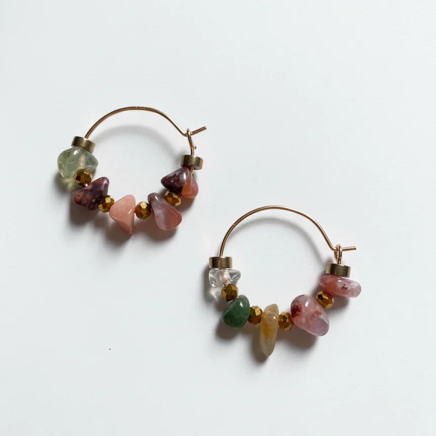Pair of hoop earrings with multicolored beads on a white background
