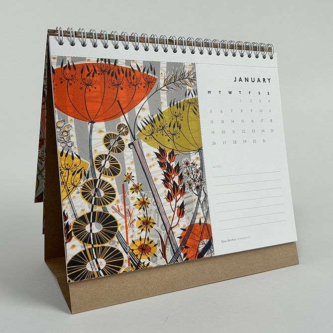 Desk calendar with floral design on a gray background