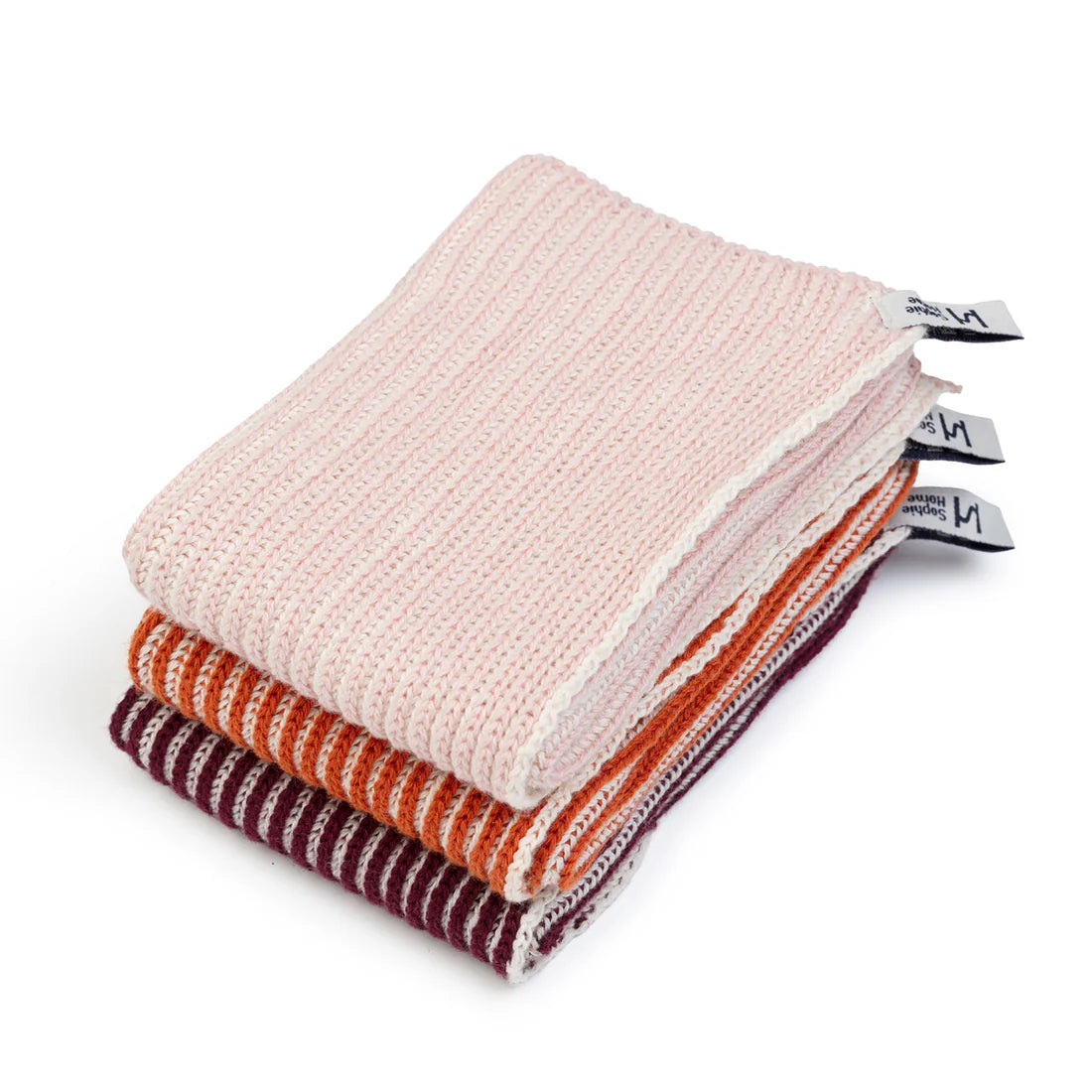 Stack of folded fabric swatches in pink, orange, and red on a white background