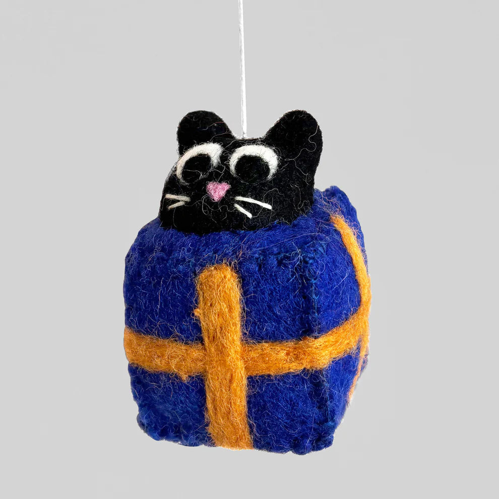 Felted cat ornament with blue and orange pattern on a gray background