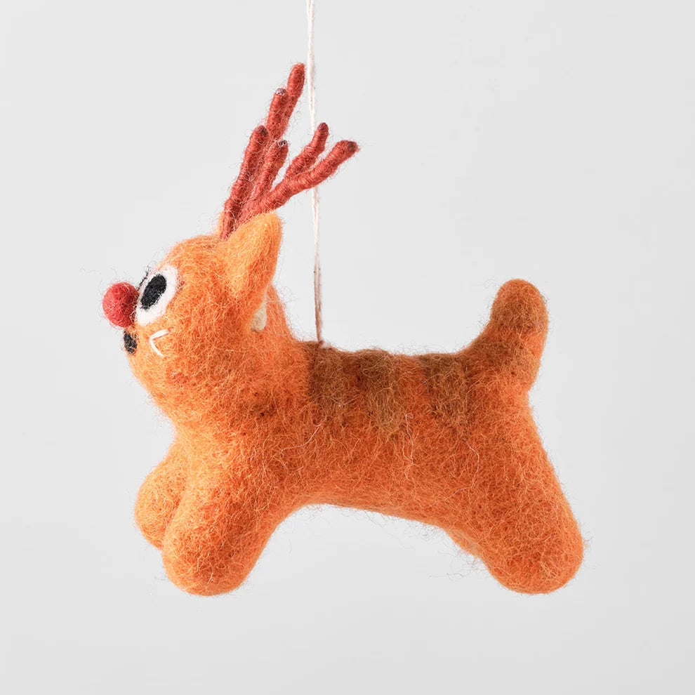 A felted wool Christmas ornament shaped like a reindeer, hanging by a thin white string against a solid light gray background.