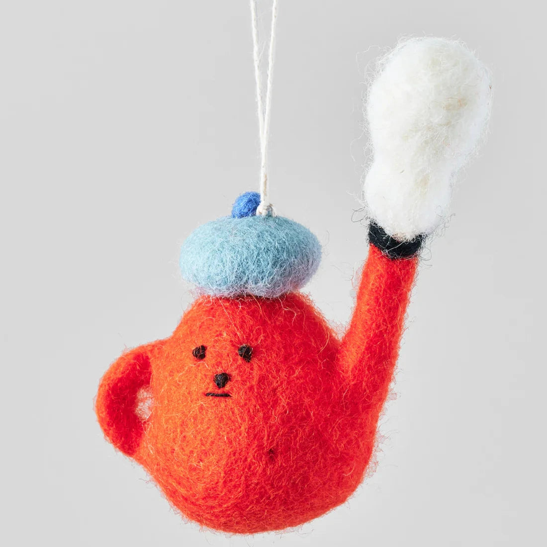 Hand-felted teapot ornament; orange body, light blue beret, white felt detail, hanging string.