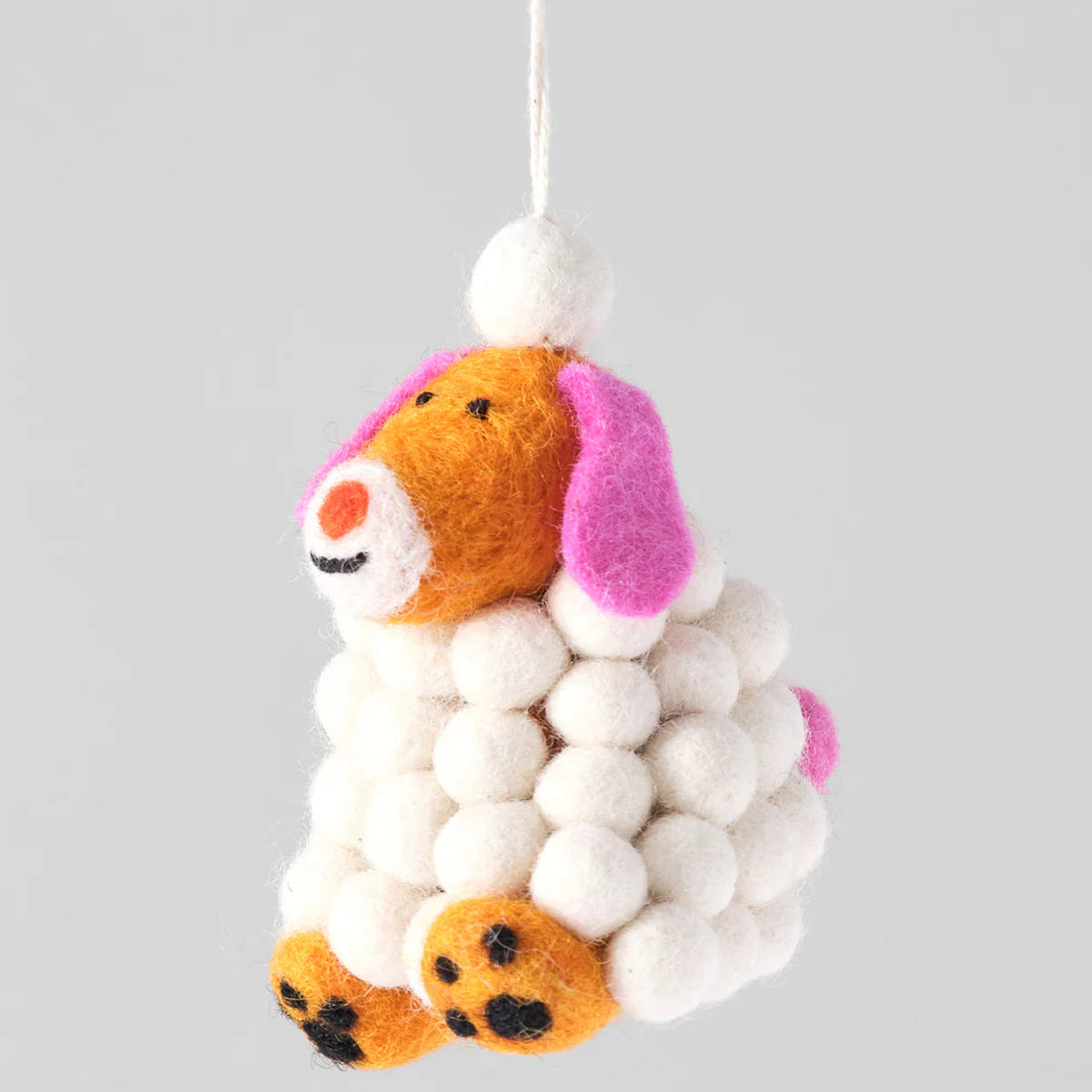 Felted animal toy with pom-pom details on a gray background, featuring a 'Pre-order' label.